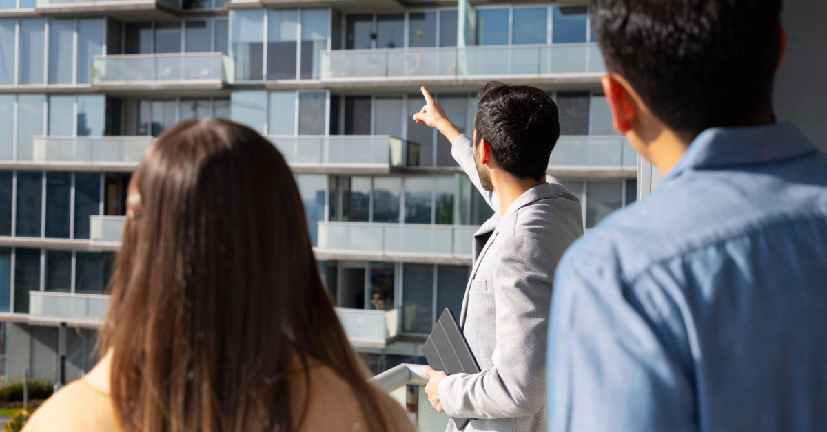 An agent showing a couple to their apartment