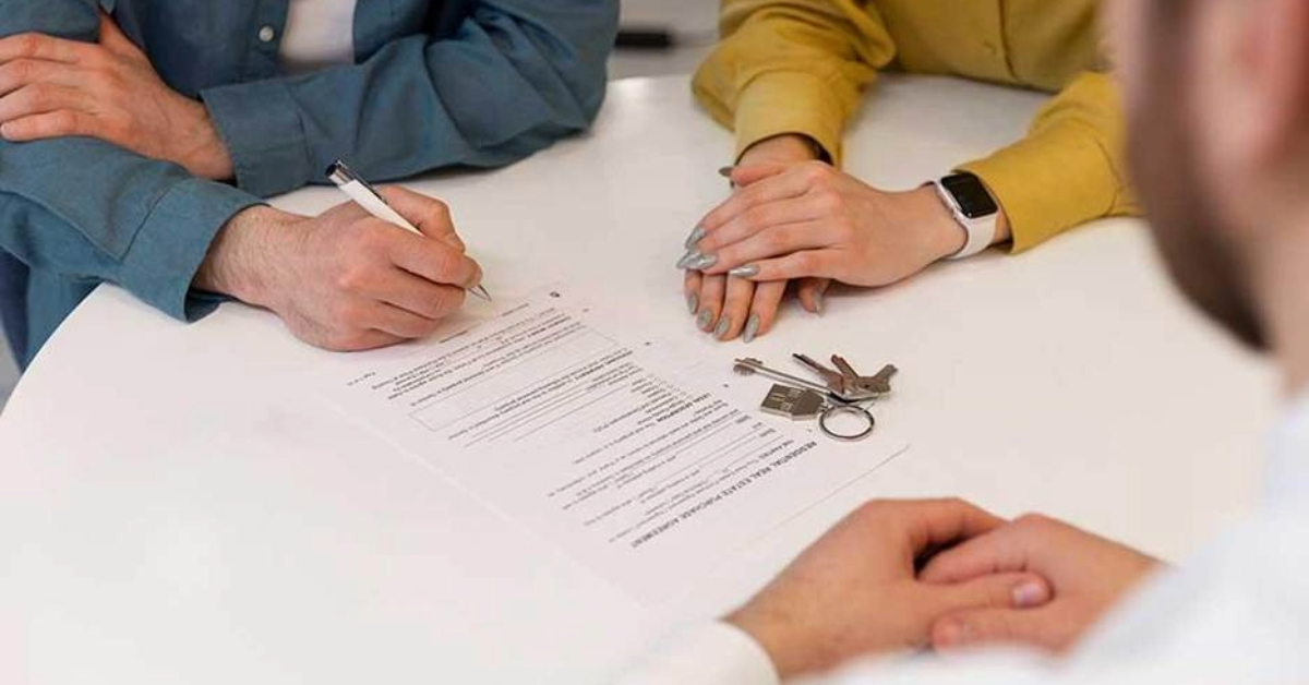A couple signing a contract for their new home