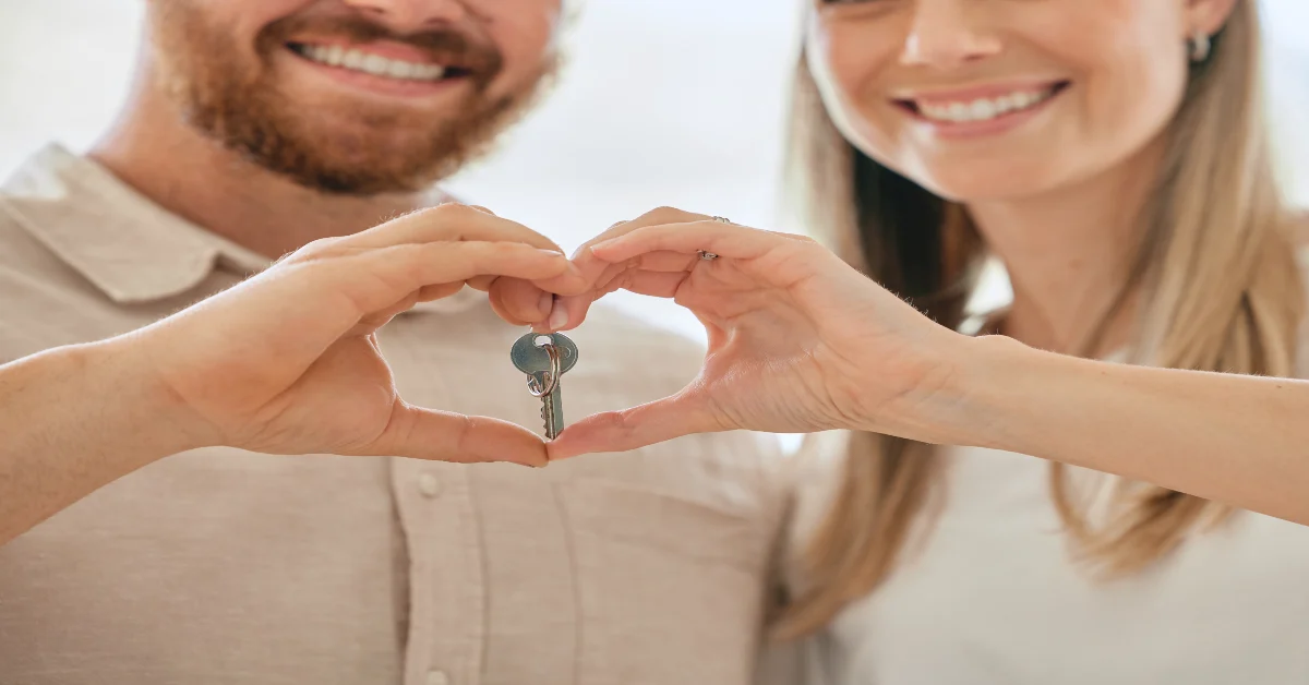 A couple holding a key after buying a property in Dubai