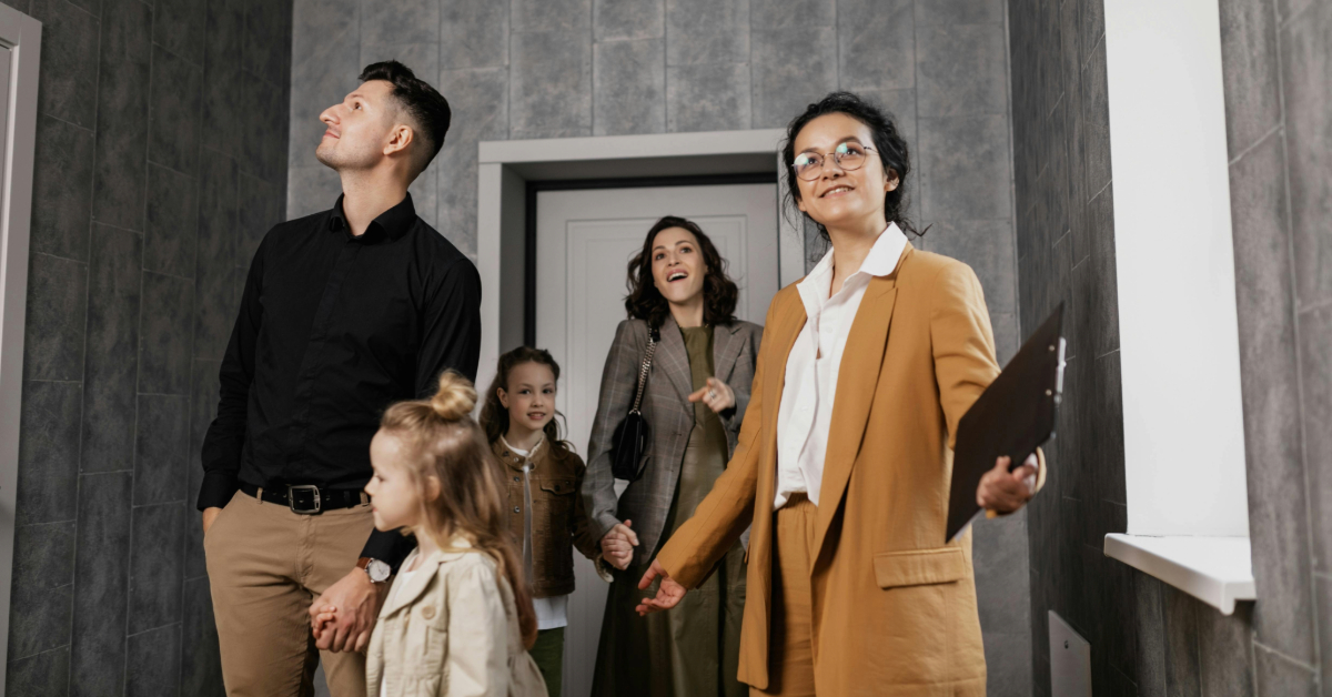 A real estate agent giving a family a house tour