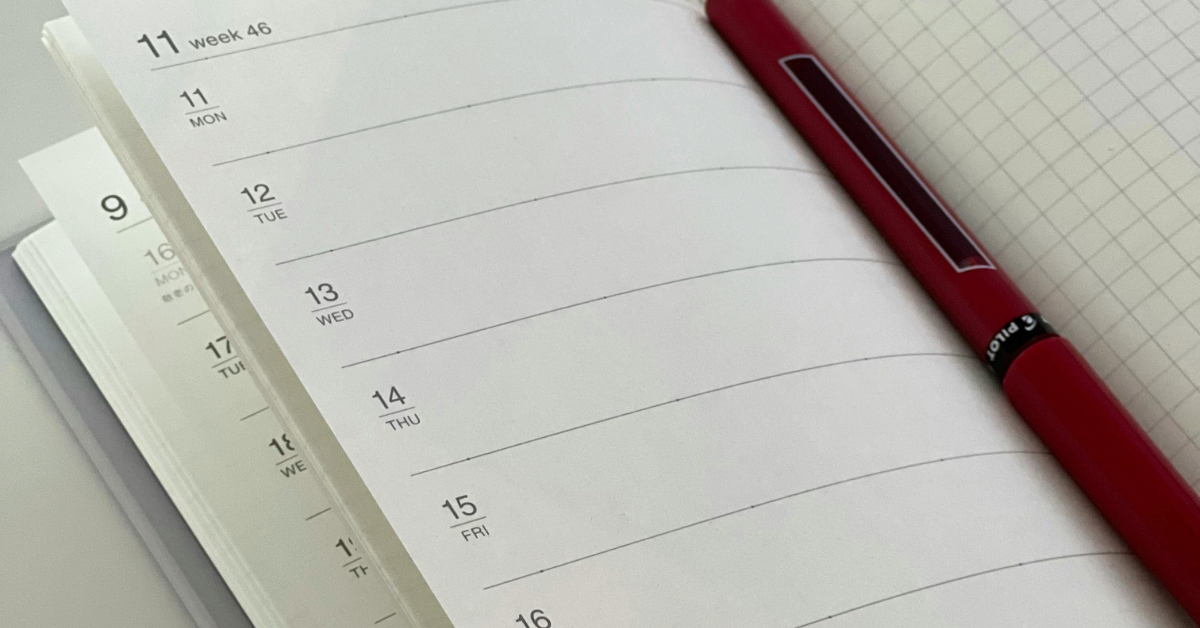 Pen sitting on a notebook with a checklist