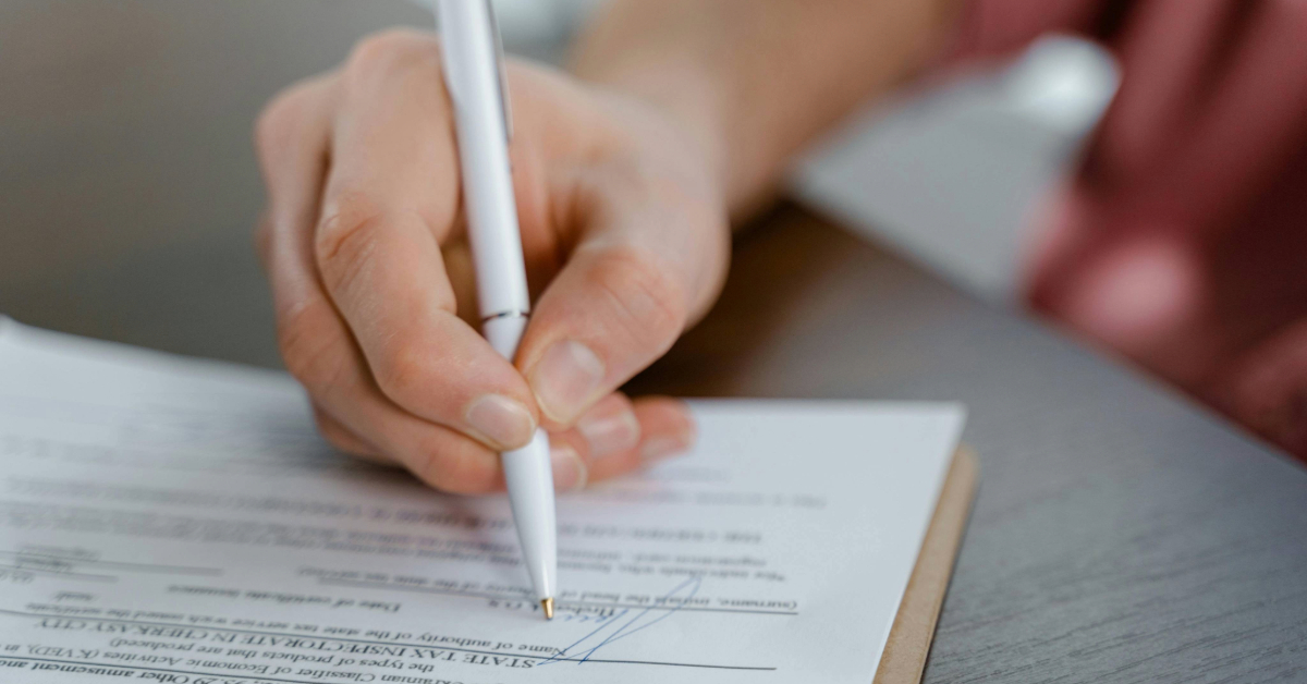 A person signing a rent document in Dubai