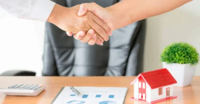 Hands of agent and client shaking hands after signed contract buy new apartment