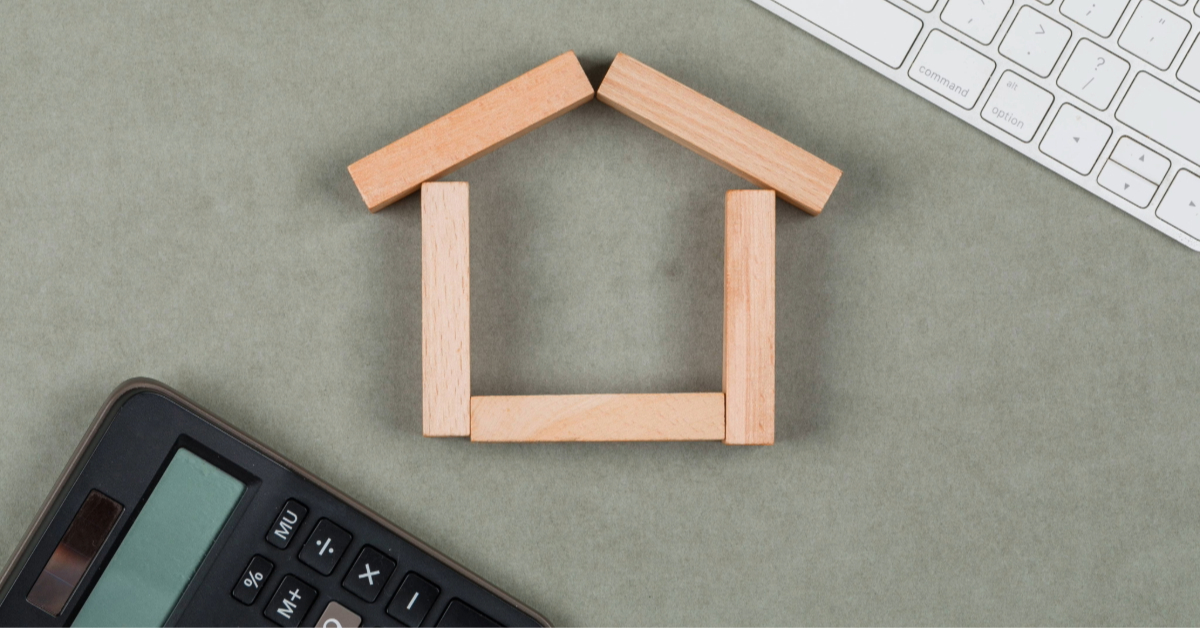 Real estate concept with wooden blocks and a calculator