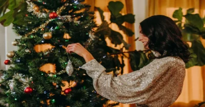 A Woman Decorating a Christmas Tree