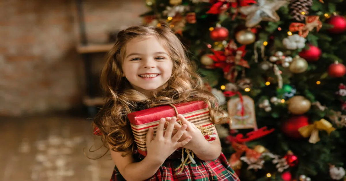Happy kid holding Christmas gift