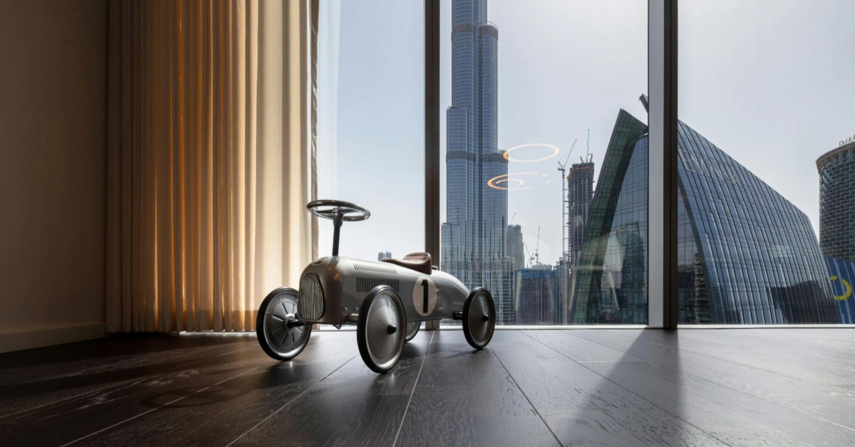 Vintage toy car in modern setting with Dubai's iconic skyline view, featuring Burj Khalifa