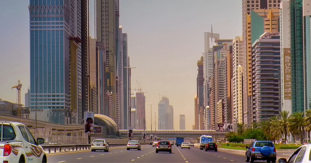 Cars on an open road with UAE skyscrapers