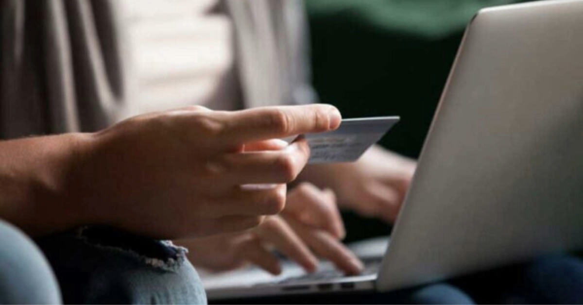 A hand holding a payment card during the Salik account registration process in Dubai