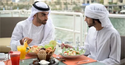 Two men eating in an iftar buffet in Dubai