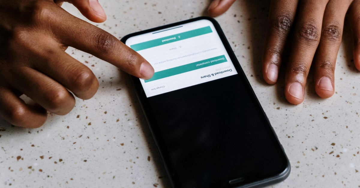 Driver using a mobile app to check road toll balance
