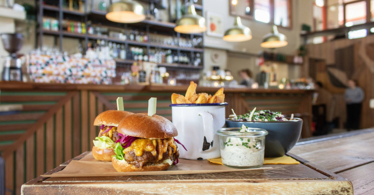 A hamburger and fries served on a wooden table