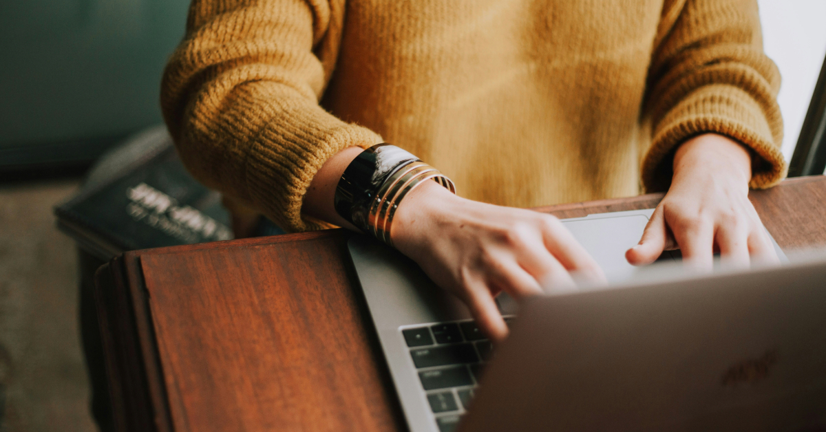A woman completing registration on her laptop