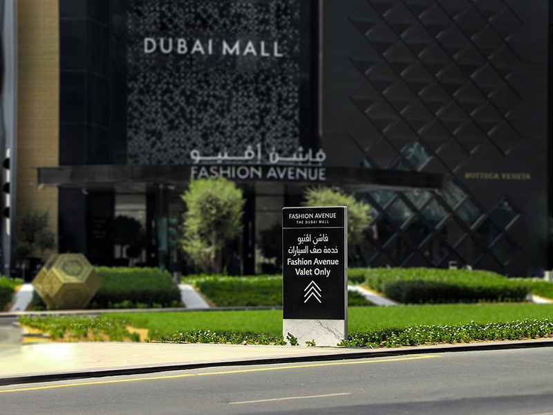 Exterior of Dubai Mall Fashion Avenue with valet parked expensive cars  outside , Downtown Dubai, United Arab Emirates