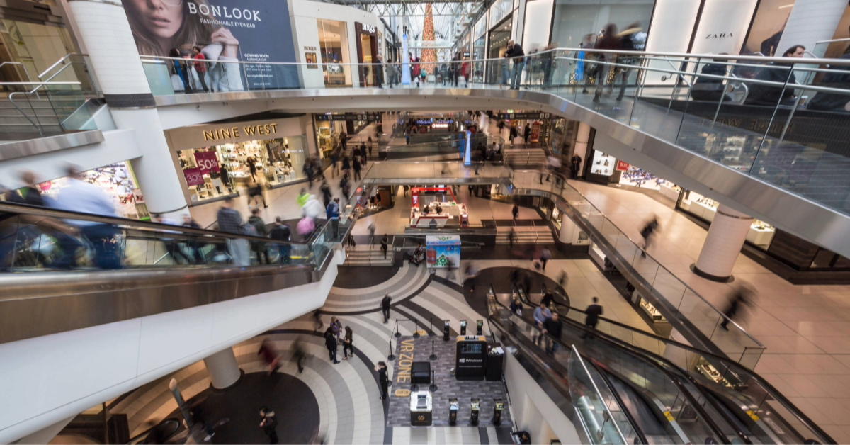 A bustling Al Wahda Mall in the evening