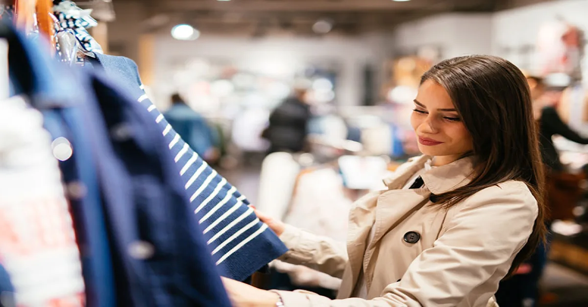 Woman choosing a tshirt from the mall