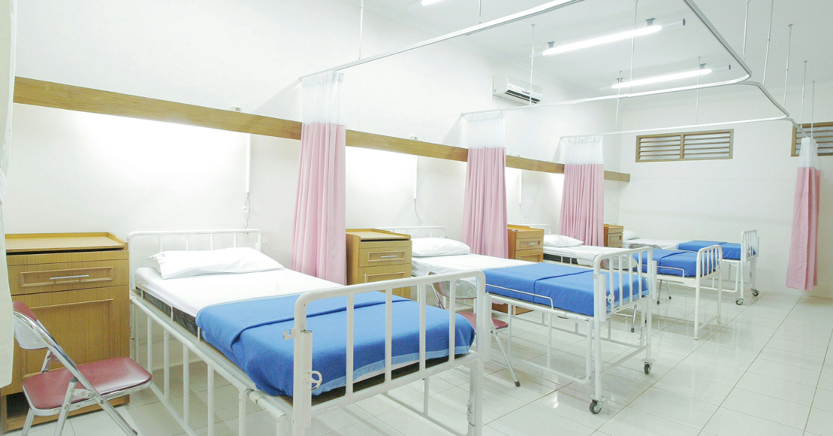 Empty hospital beds inside a room