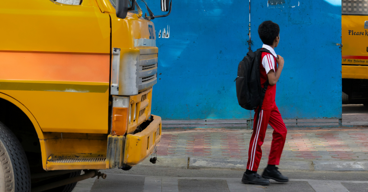 A schoolboy walking into the school