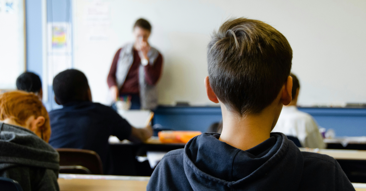 A classroom filled with students and a teacher