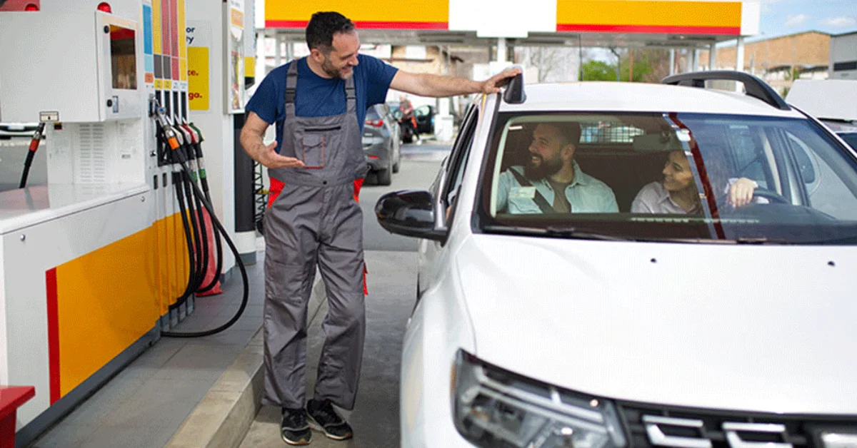 A man asking about petrol prices in a UAE gas station