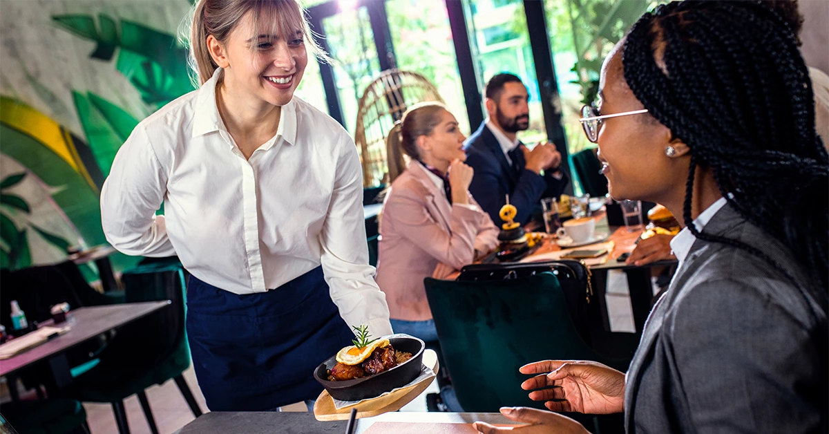 Waitress serving a meal in a restaurant