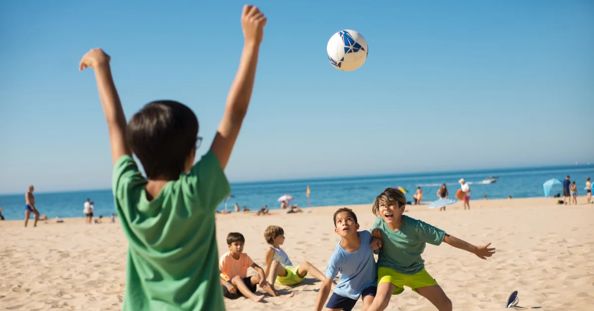 Kids playing beach volleyball