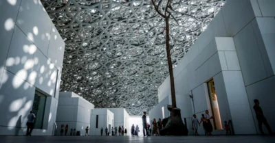 Low-angle shot of the Louvre Abu Dhabi with a dark, dramatic aesthetic