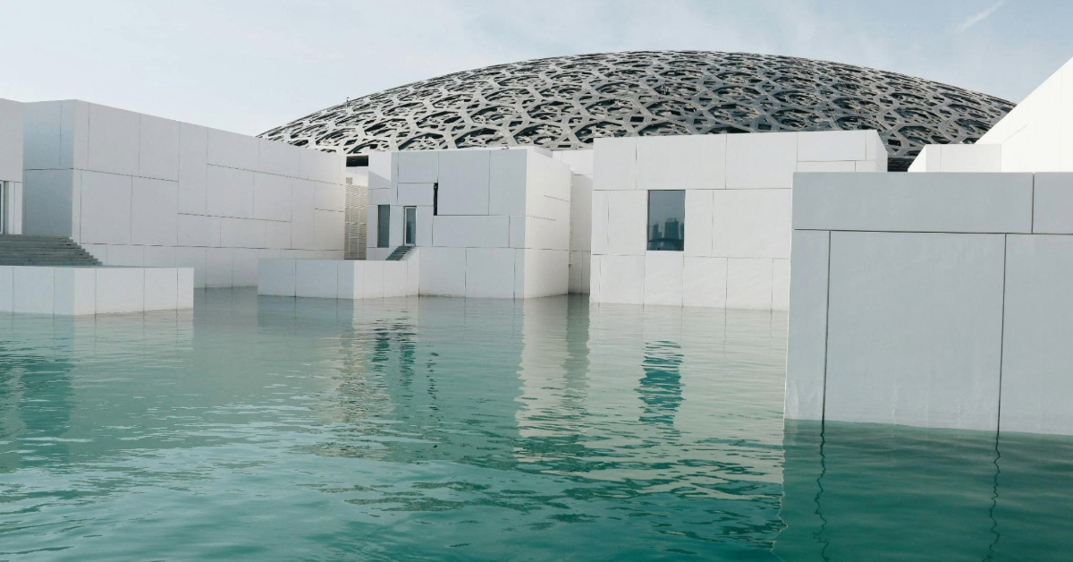 A view of the Louvre Abu Dhabi surrounded by water