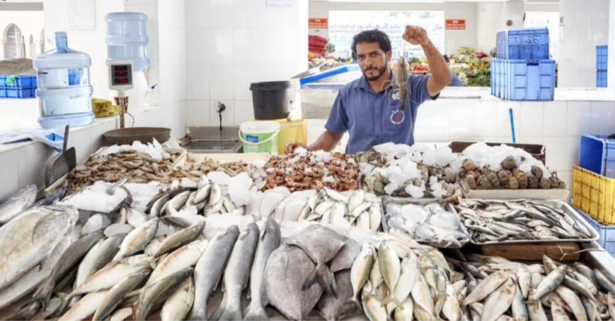 A man selling fish in Ajman fish market