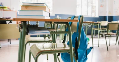 School classroom with books and backpack