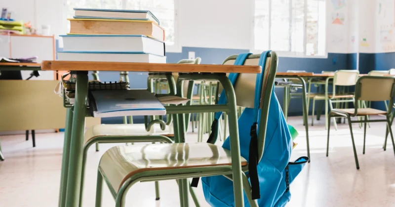 School classroom with books and backpack