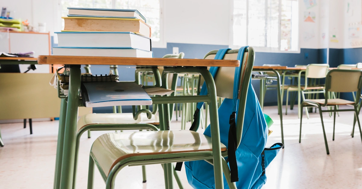 School classroom with books and backpack