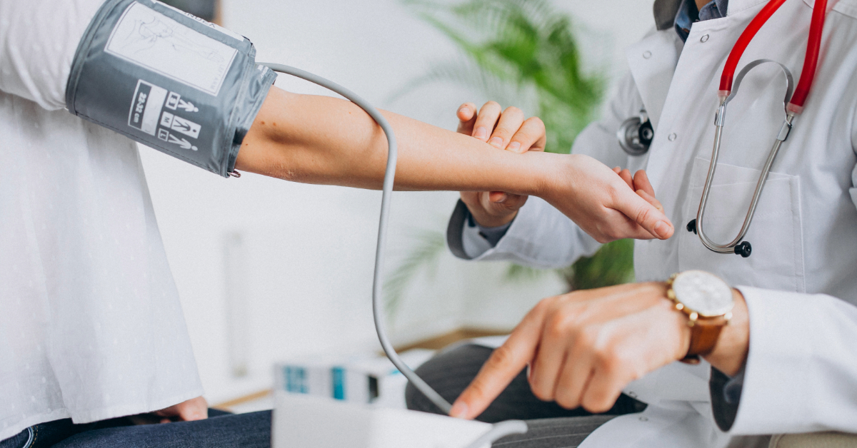 A doctor checking a patient’s blood pressure