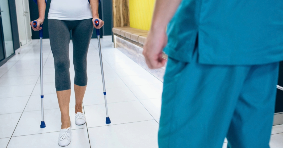 Patient Walking With Crutches on a Hospital Corridor