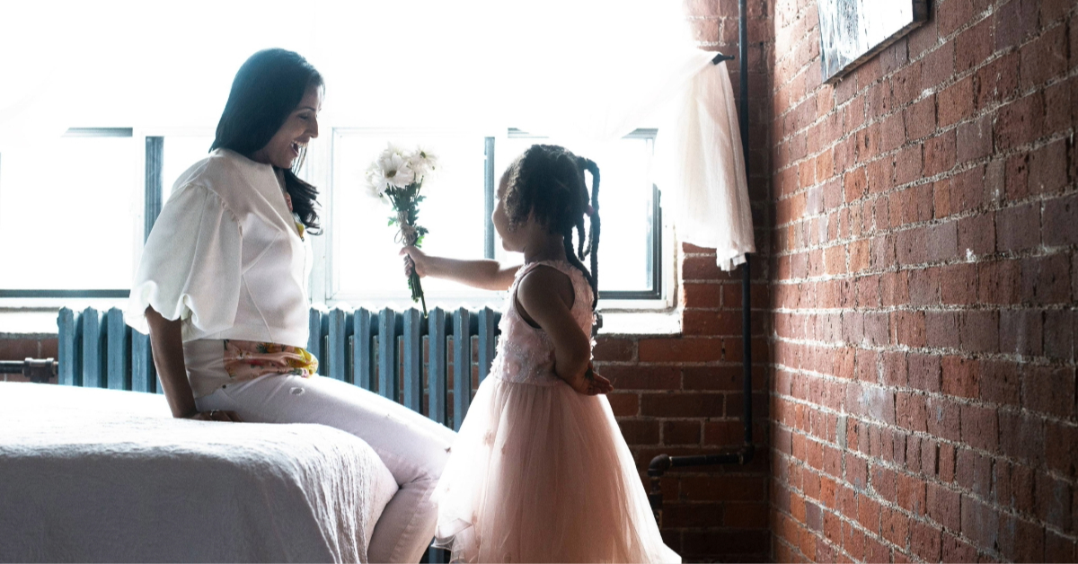 A little girl gifting flowers to her mother on Mother’s Day