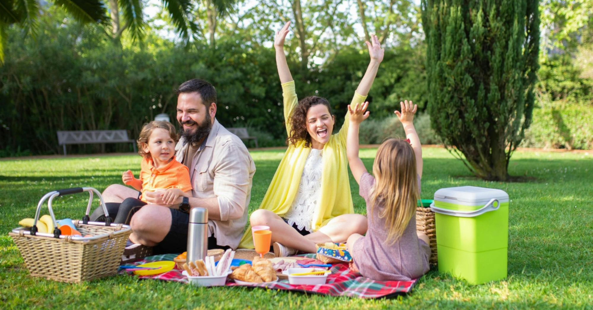 Family enjoying a picnic in a vast garden
