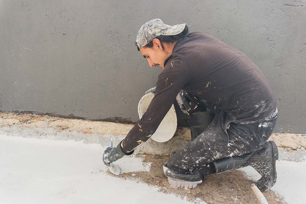 staff of waterproofing company working on a project