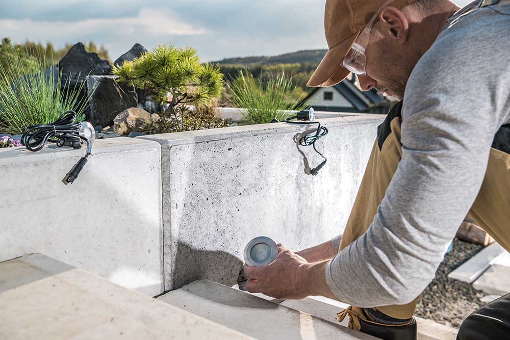 person waterproofing a house's roof