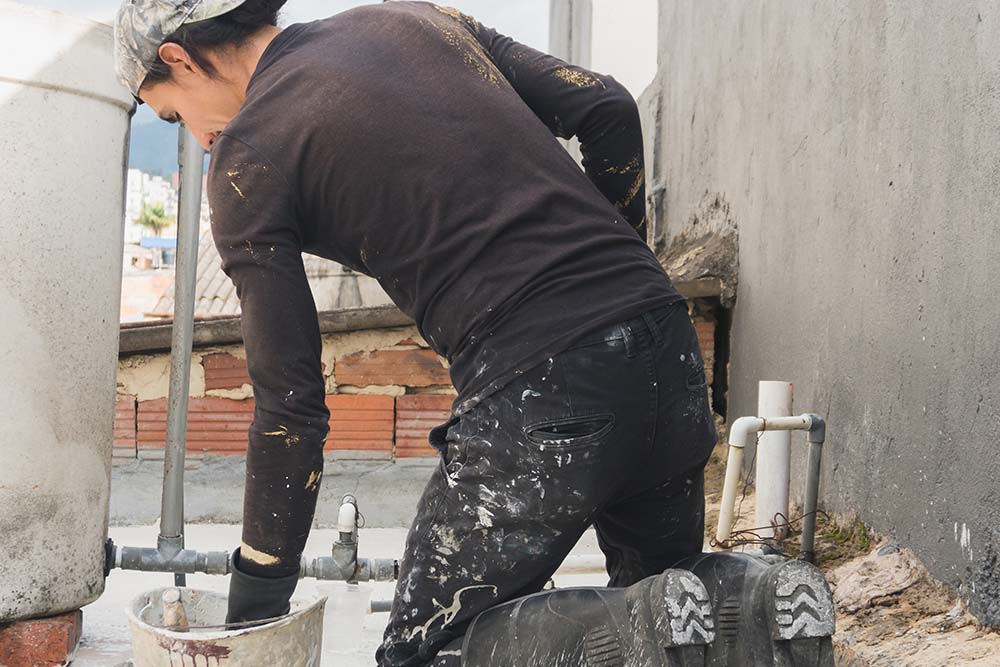 staff working on a house's roof