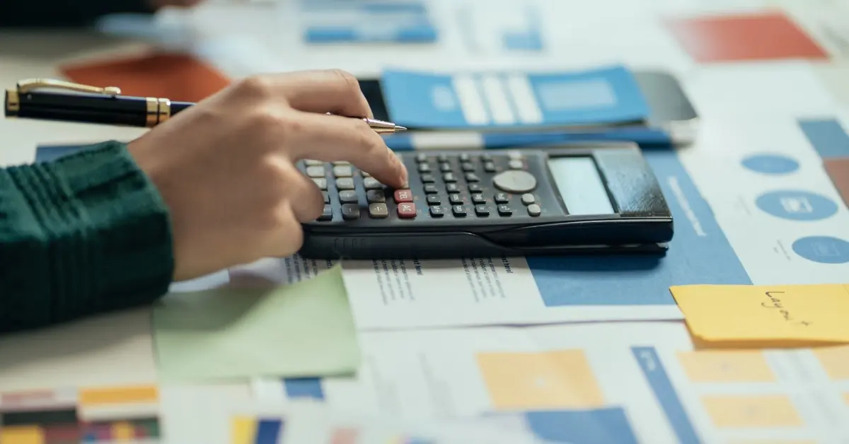 A woman calculating her gratuity using a calculator in the UAE