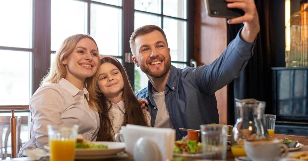A family enjoying a delicious lunch outdoors at a restaurant