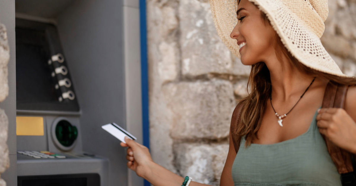 A woman using her card to access the ATM