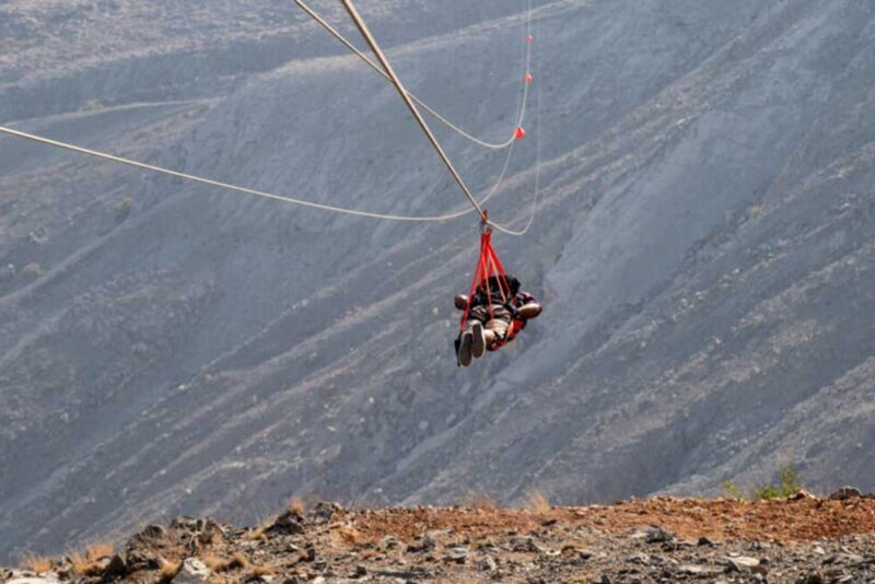 view of the thrilling Jebel Jais Zipline, against the rugged mountains of Ras Al Khaimah 