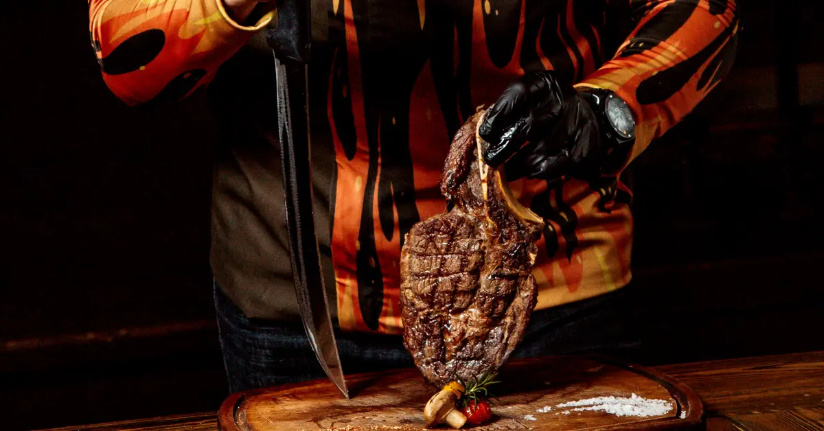 Chef puts fried meat on the cutting board