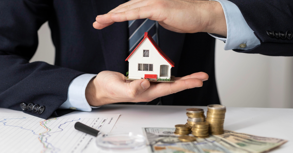 A man holding a house figure