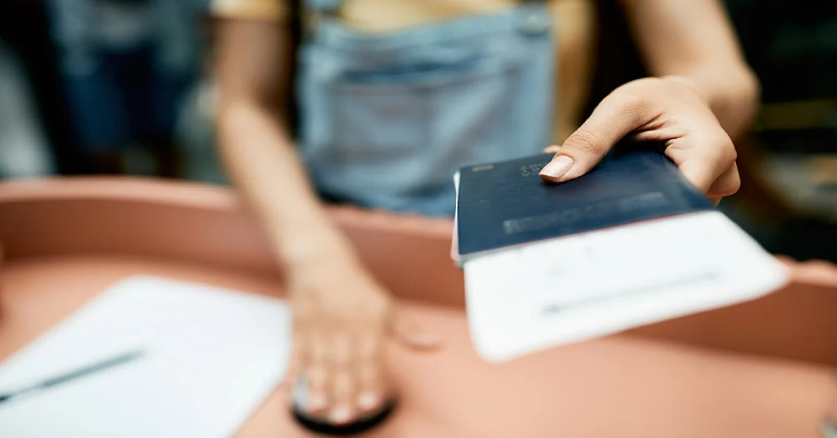 A girl handing her documents and passport