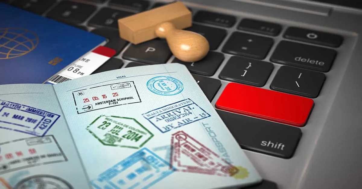 passport and stamp on a laptop