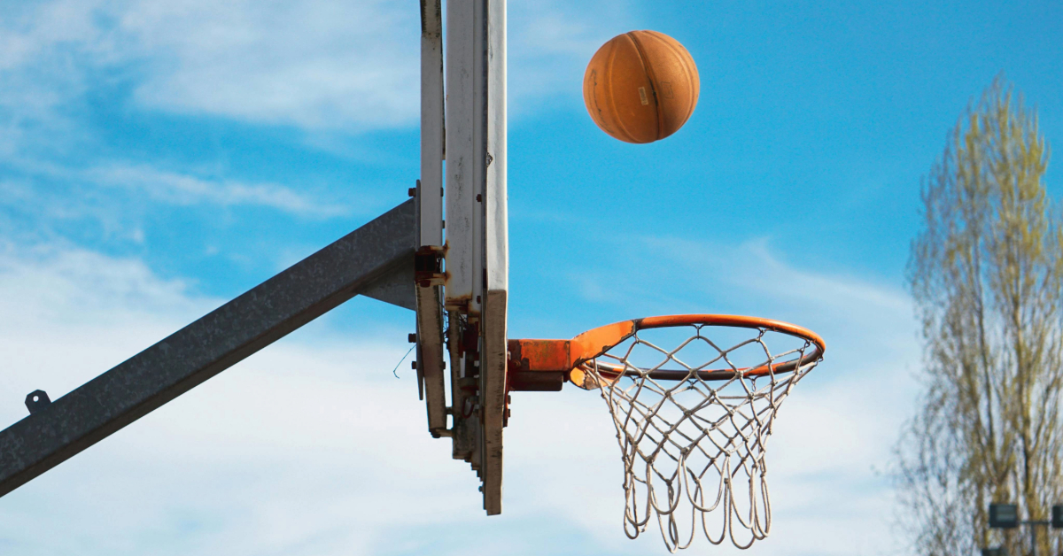 Basketball hoop with the ball about to fall in