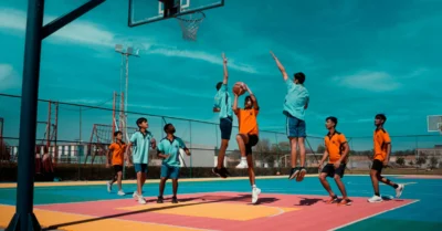 Youth playing basketball in an outdoor court
