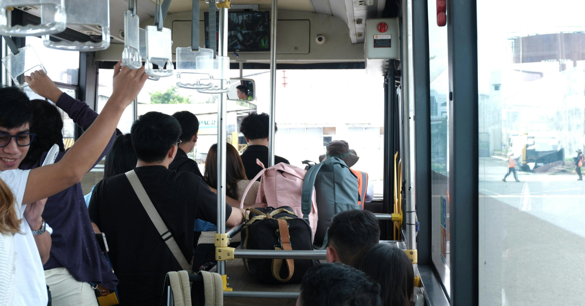 People getting ready to get off a bus